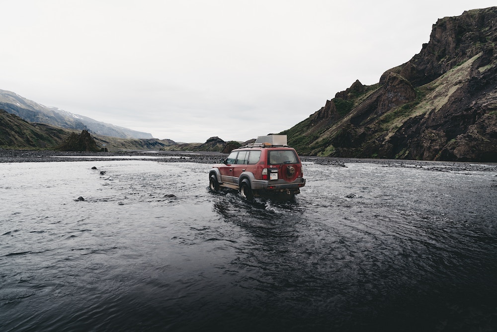 Gas Guzzling SUV Riverbed Mountains